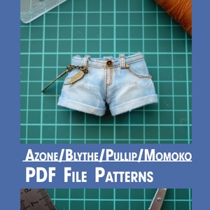 May include: A blue denim shorts pattern for dolls like Azones, Blythes, Pullips, and Momokos. The PDF file pattern is for sewing a pair of denim shorts with a cuffed hem and a decorative wing charm.
