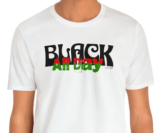 May include: White t-shirt with a black and green graphic that says "Black All Day" with the word "Black" in a stylized font and the words "All Day" in a red, green, and black color scheme. The text "EST. 1970" is in small white letters below the graphic.