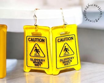 Caution Slippery When Wet Sign Dangle Earrings: Raunchy Statement Accessory