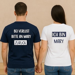 May include: Two people wearing matching t-shirts with text. One shirt is navy blue with the text "BEI VERLUST BITTE AN MARY ZURÜCK" in white. The other shirt is white with the text "ICH BIN MARY" in navy blue.