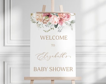 May include: A white welcome sign with a floral design in shades of pink and green. The sign reads "Welcome to Elizabeth's Baby Shower".