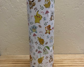 May include: White stainless steel tumbler with a colorful pattern of Pokemon characters, including Pikachu, Bulbasaur, Charmander, Squirtle, and others. The tumbler has a white lid.