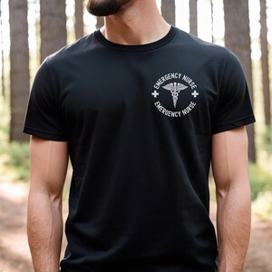May include: A black t-shirt with a white graphic of a medical symbol and the text "Emergency Nurse" on the front.