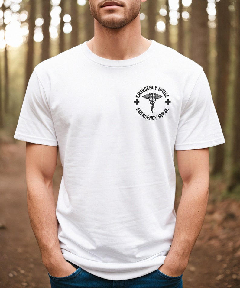 May include: White t-shirt with a black and white graphic of a medical symbol and the text "Emergency Nurse" on the front.
