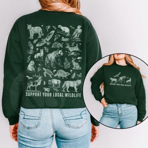 Sudadera con texto "Apoya la fauna local" para amantes de la naturaleza. Sudadera con estampado "Granola Girl" (delante y detrás) sobre animales en peligro de extinción. Sudadera con estampado "Apoya la fauna local" para amantes de los animales del Medio Oeste.