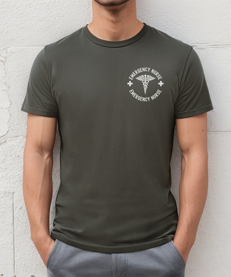 May include: A dark green t-shirt with a white circle graphic featuring a caduceus symbol and the text "Emergency Nurse" repeated twice.