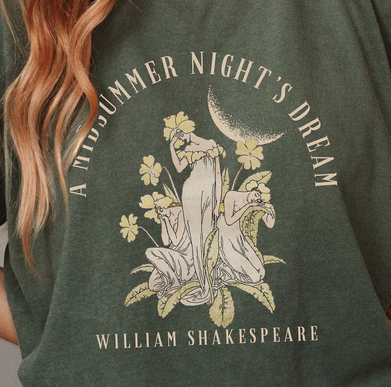 May include: A green t-shirt featuring a vintage illustration of three women in a garden with the text "A Midsummer Night's Dream" and "William Shakespeare".