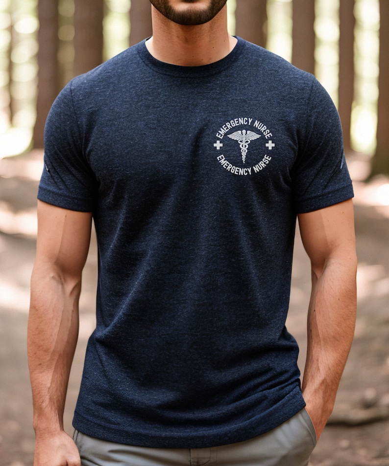 May include: A navy blue t-shirt with a white graphic of a medical symbol and the text "Emergency Nurse" on the front.