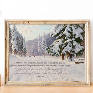 May include: A framed print of a wintery forest scene with snow-covered trees. The print features a quote from Isaiah 9:6: "For unto us a child is born, unto us a son is given: and the government shall be upon his shoulder: and his name shall be called Wonderful, Counsellor. The mighty God, The everlasting Father, The Prince of Peace."