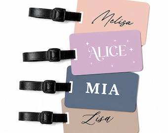 May include: Four personalised luggage tags in pastel shades: pink, lilac, blue, and beige. Each tag has a black leather strap and buckle. The names "Melisa", "Alice", "Mia", and "Lisa" are printed on the tags in elegant script.