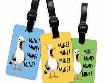 May include: Three luggage tags with black straps. Each tag features a cartoon seagull illustration and the word "MINE!" repeated. The tags are coloured blue, yellow, and green.