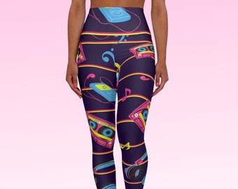 May include: Purple leggings with a retro music theme. The leggings feature a repeating pattern of cassette tapes, headphones, and music notes in pink, yellow, and blue.