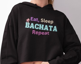 May include: Black cropped hoodie with a graphic print that says "Eat, Sleep, Bachata, Repeat".