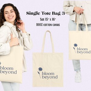 Puede incluir: Bolso tote color crema hecho de lona 100% algod&oacute;n. La bolsa mide 38 cm x 41 cm y presenta un dise&ntilde;o floral azul marino con las palabras "bloom beyond". La bolsa es sostenida por una persona en la imagen.