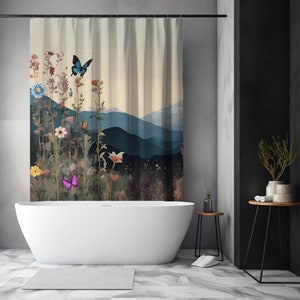 May include: A shower curtain with a watercolor design of a mountain range with a field of flowers and butterflies in front of it. The curtain is hanging in a bathroom with a white bathtub and a black and white tiled floor.