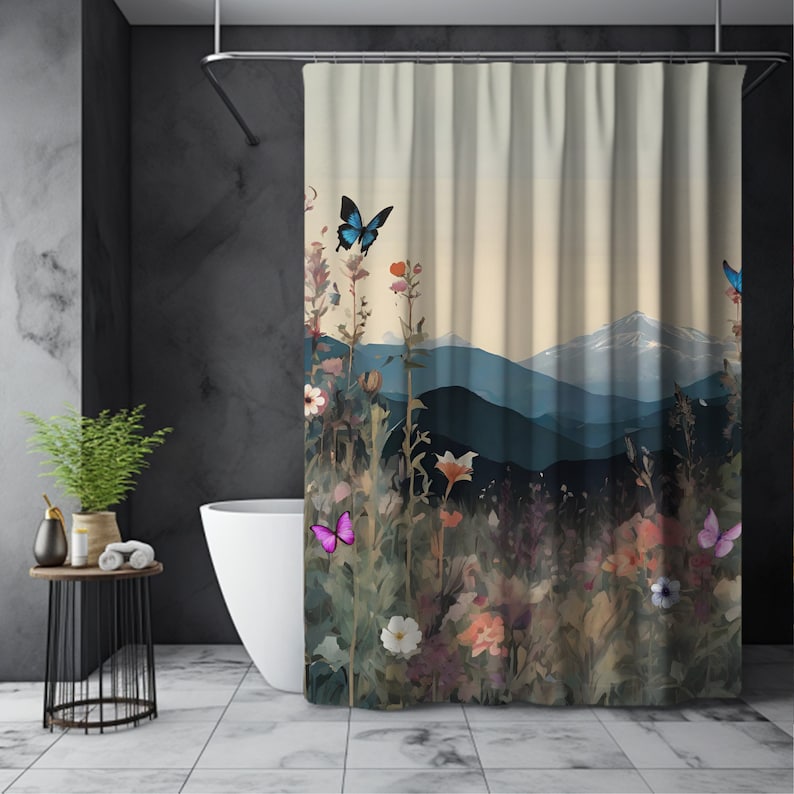 May include: A shower curtain featuring a watercolor-style landscape with a mountain range in the background. The foreground features a field of wildflowers and butterflies in shades of blue and pink.