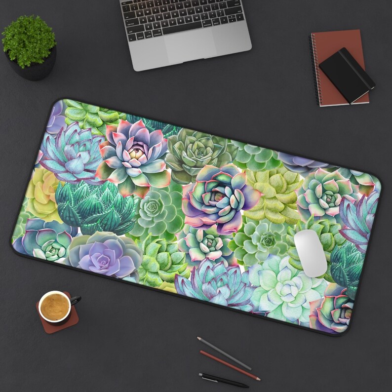 May include: A colorful desk mat featuring a watercolor pattern of succulents in shades of green, pink, purple, and blue. The mat is perfect for protecting your desk surface and adding a touch of nature to your workspace.