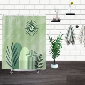 May include: A green shower curtain with a stylized sun, leaves, and abstract shapes. The curtain has a white background with a subtle watercolor effect.