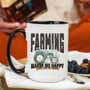 May include: White ceramic mug with a black interior and handle. The mug features the text "FARMING" in bold black letters, with a light blue tractor graphic. Below the tractor, the text reads "MAKES ME HAPPY, You, not so much."