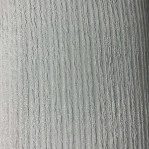 Puede incluir: Primer plano de una tela blanca con una superficie texturizada y acanalada. La tela tiene líneas verticales y una textura ligeramente irregular, creando un patrón sutil. El color es un blanco brillante y limpio, lo que sugiere una estética limpia y moderna.