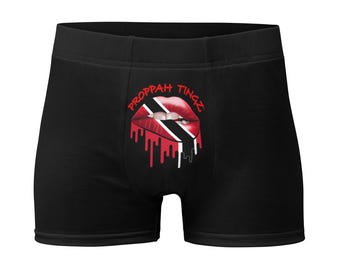 Calzoncillos tipo bóxer negros: diseño de labios con la bandera de Trinidad. Color de la marca: rojo.