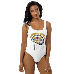 One-Piece Swimsuit White: Virgin Islands flag lip design. Brand name yellow/black tracing.