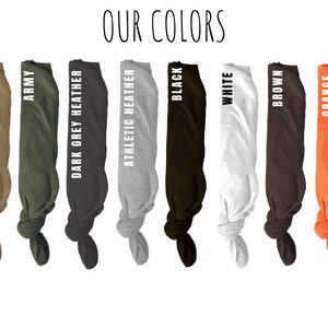 May include: A display of t-shirt colors, including Heather Olive, Army, Dark Grey Heather, Athletic Heather, Black, White, Brown, and Orange. The text "OUR COLORS" is at the top of the image.