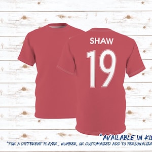 May include: Red soccer jersey with white text and number "SHAW 19". Available in kids sizes.