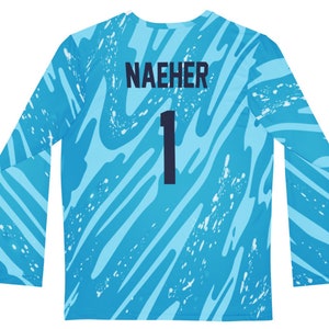 Puede incluir: Una camiseta de f&uacute;tbol azul de manga larga con un patr&oacute;n abstracto blanco y azul. La camiseta tiene el nombre "NAEHER" y el n&uacute;mero "1" en la espalda.