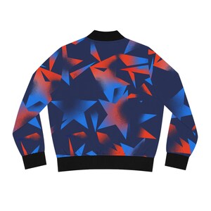 May include: A navy blue bomber jacket with a vibrant star pattern in shades of red and blue. The jacket features a black collar, cuffs, and hem. The star design is a repeating pattern across the jacket's surface.