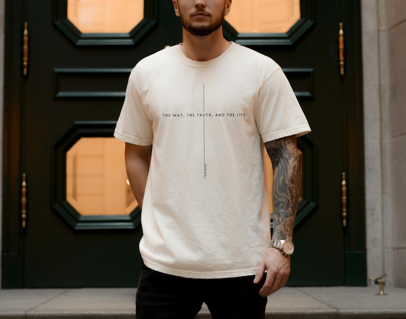 May include: A white t-shirt with the text "THE WAY, THE TRUTH, AND THE LIFE" printed on the front. The text is centred and aligned vertically.
