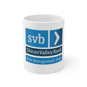 May include: White ceramic mug with a blue and white logo that says "svb Silicon Valley Bank Risk Management Dept."