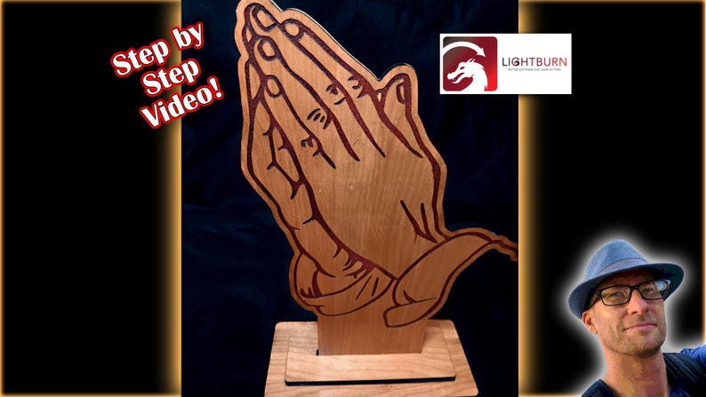 May include: A wooden sculpture of praying hands, with detailed lines and a natural wood grain finish. The hands are depicted in a clasped position, mounted on a rectangular base. The image includes the text "Step by Step Video!" and a logo for Lightburn.