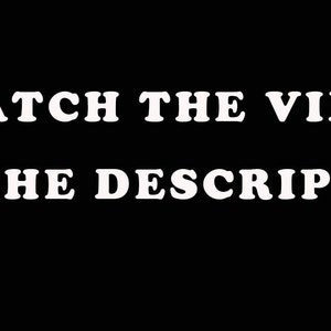 May include: Black background with white text that reads "WATCH THE VIDEO IN THE DESCRIPTION". The text is in a bold, sans-serif font. The image is simple and direct, conveying a clear message.