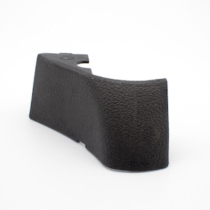 May include: Black plastic car part with a textured surface.