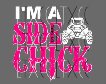 May include: Pink graphic text that reads "I'm a Side by Side Chick" with a white silhouette of a side-by-side vehicle.