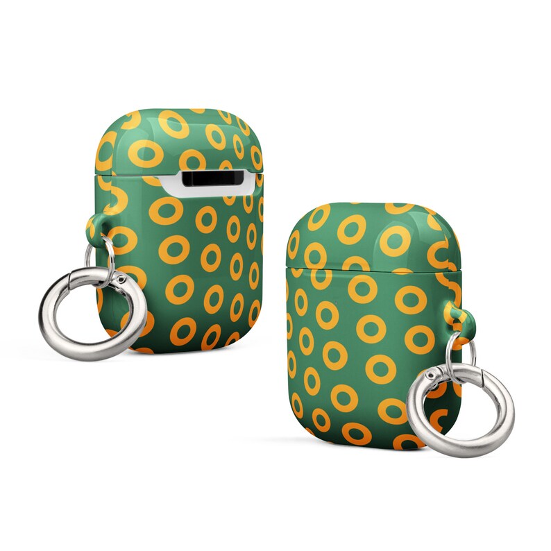 Peut inclure: Une coque pour Airpods verte et orange avec un motif de beignets et un porte-cl&eacute;s argent&eacute;.