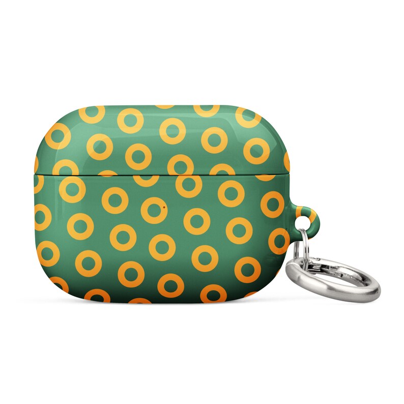 Peut inclure: &Eacute;tui pour Airpods vert et orange avec un motif de beignets et un porte-cl&eacute;s argent&eacute;.
