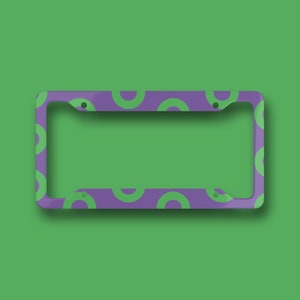 May include: Purple license plate frame with a green circle pattern.