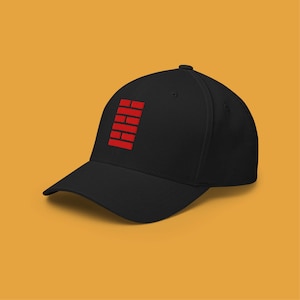 May include: Black baseball cap with a red brick-like design on the front. The cap has a curved brim and a structured fit. The design is a series of stacked red rectangles.
