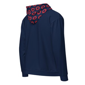 May include: Navy blue hoodie with a red circular pattern on the hood lining. The hoodie has a full zip and long sleeves. The back view of the hoodie is shown.