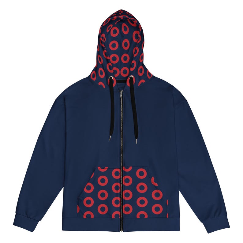 May include: Navy blue zip-up hoodie with a red circular pattern on the hood and pocket lining. The hoodie has a black zip and drawstrings. A casual, comfortable garment.