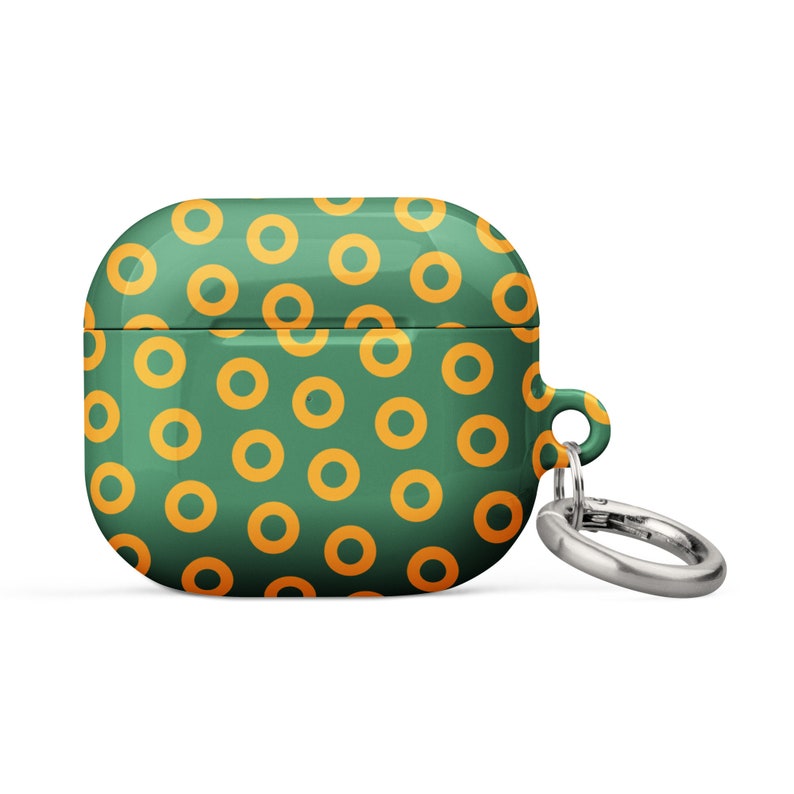 Peut inclure: &Eacute;tui pour Airpods vert et orange avec un motif de beignets et un porte-cl&eacute;s argent&eacute;.