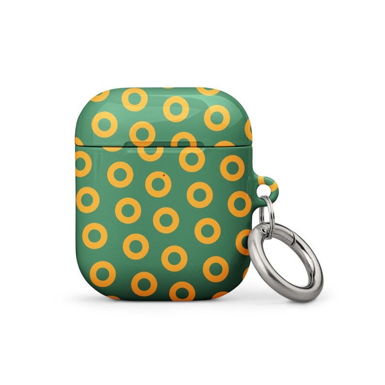 Peut inclure: &Eacute;tui pour AirPod vert et jaune avec un motif de beignets et un porte-cl&eacute;s argent&eacute;.