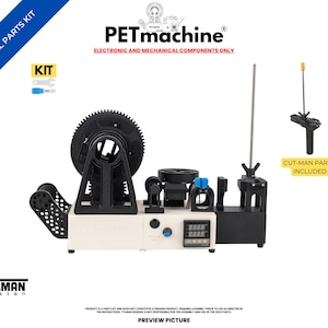 May include: A PETmachine essential parts kit featuring electronic and mechanical components. The kit includes a beige base unit with a digital display, a large black gear, and various assembly parts. Text includes PETmachine, KIT, and CUT-MAN PARTS INCLUDED.