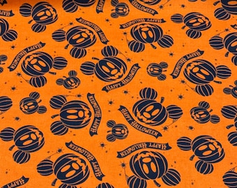 May include: Orange fabric with a repeating pattern of black Mickey Mouse heads shaped like pumpkins. The pumpkins have a jack-o-lantern face and the text "Happy Halloween" is written on a banner.