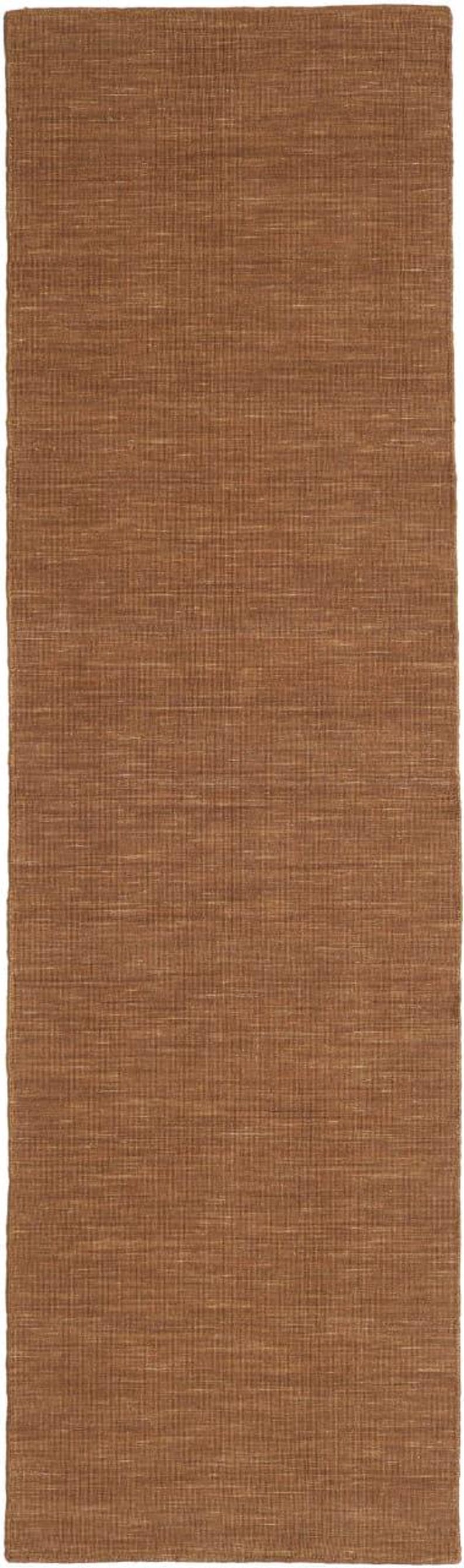 May include: A rectangular brown rug with a woven texture. The rug has a natural, earthy tone and a simple, yet elegant design. The weave pattern creates a subtle grid-like effect.