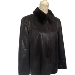 May include: A black leather jacket with a faux fur collar. The jacket has a zipper closure and a textured pattern.