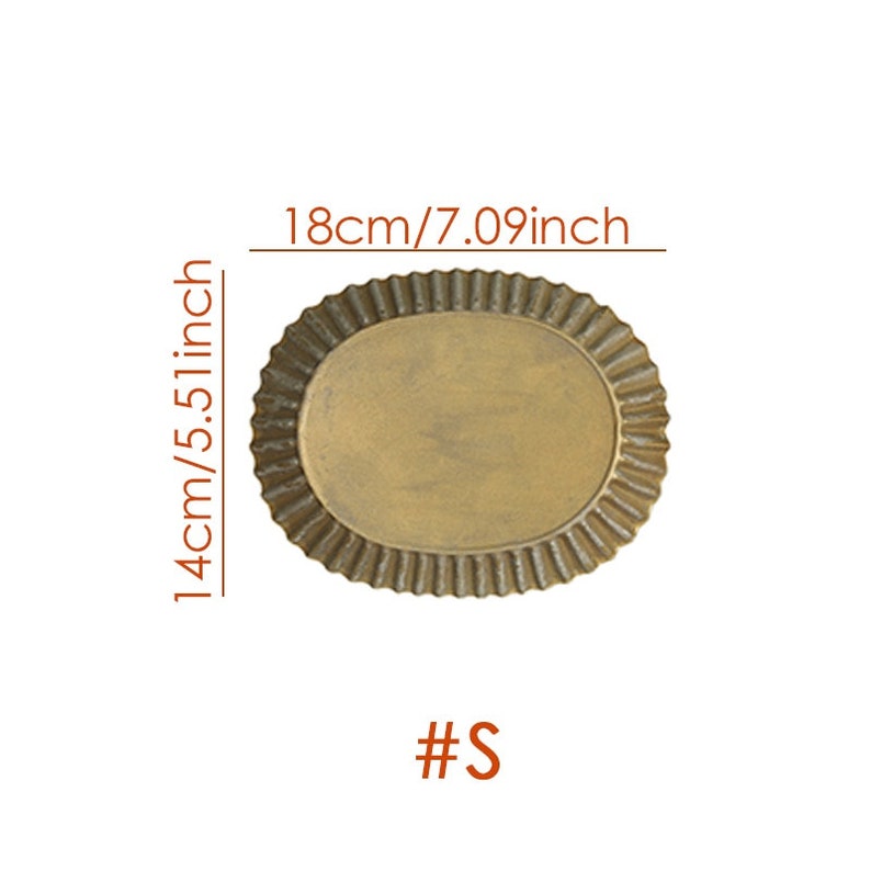 May include: A gold-colored, oval-shaped metal tray with a fluted edge. The tray measures 18 inches in length and 14 inches in width. The tray is labeled with the size "#S".
