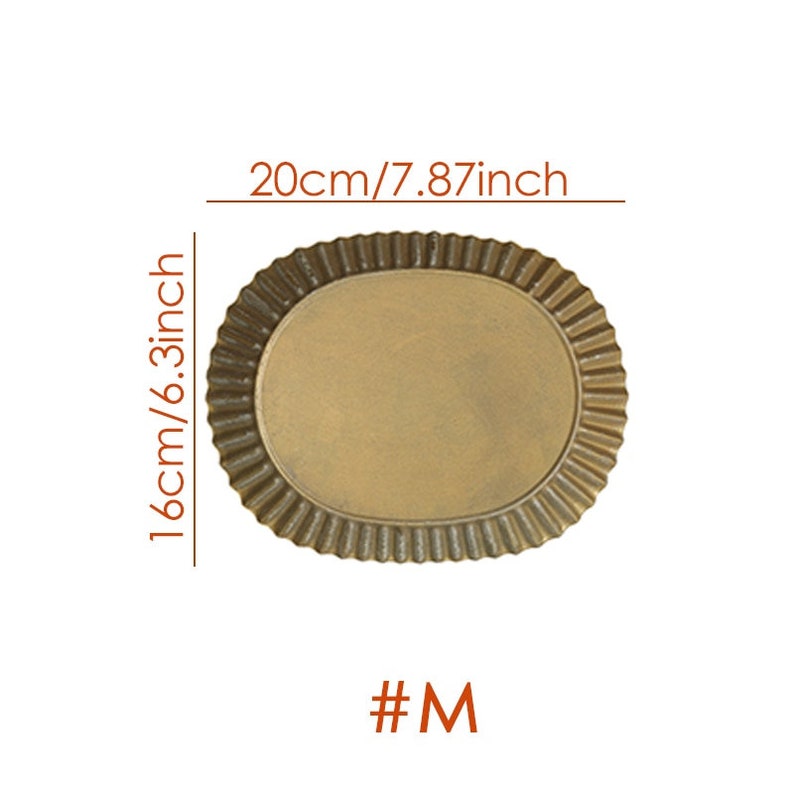 May include: A gold-colored metal oval baking pan with a fluted edge. The pan measures 7.87 inches wide and 6.3 inches long. #M